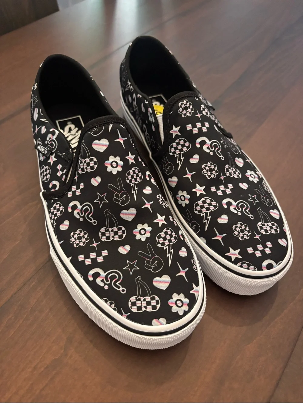 Vans Women’s Black Slip-On Sneakers with Multicolor Icon Accents